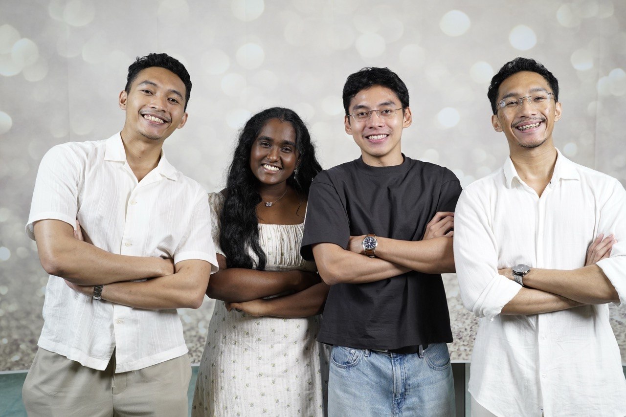 Team Delphium studio portrait — four members